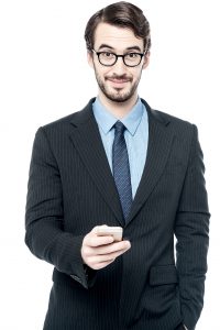 Young business man posing with mobile phone