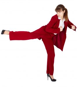 Young woman in a business suit kicks back