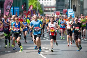 A large group of people competing in a running marathon