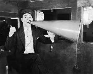 Man speaking into a huge megaphone