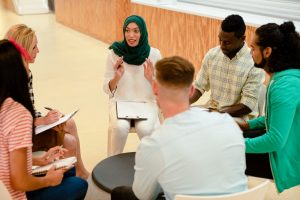 A diverse group of people conversing during a meeting