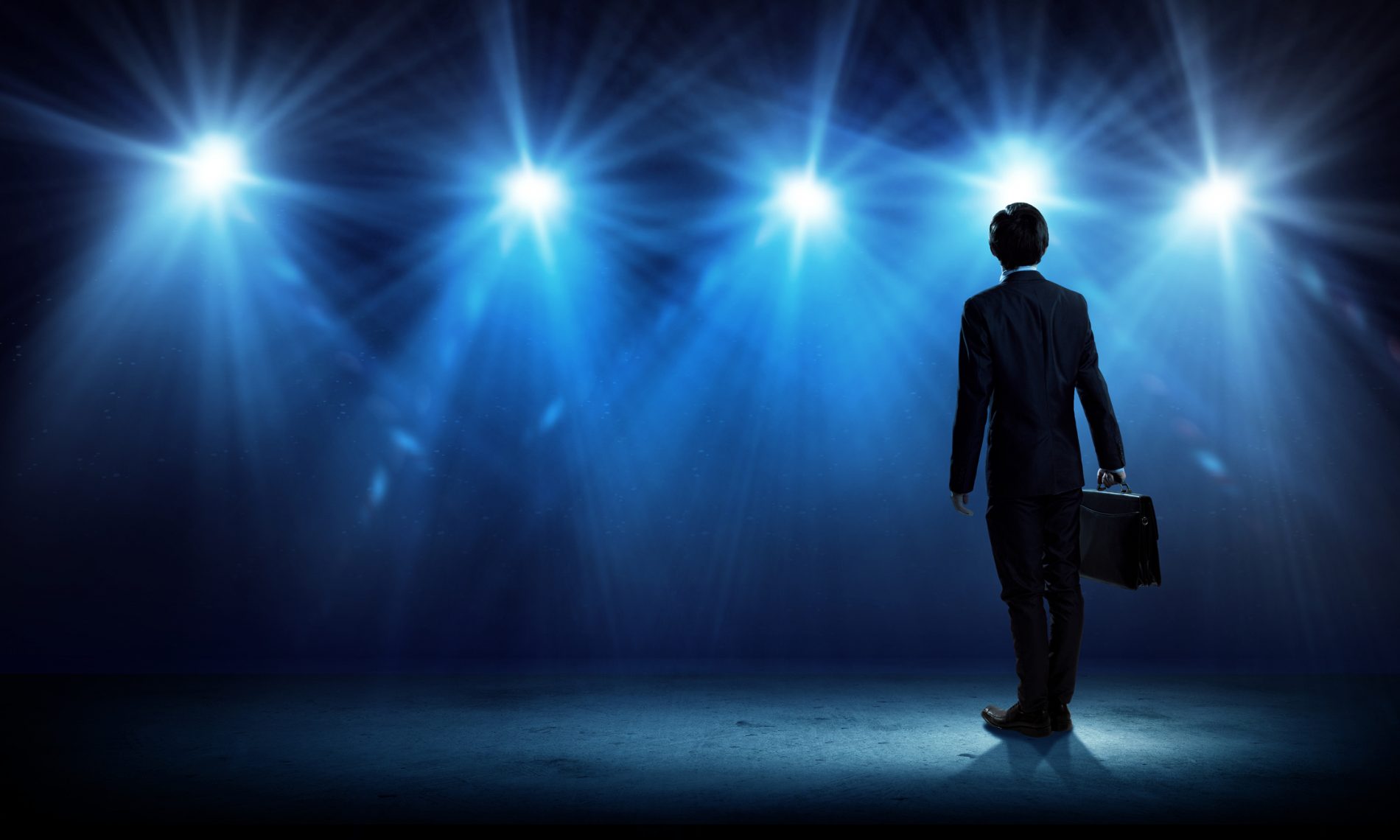 Business person standing in the lights