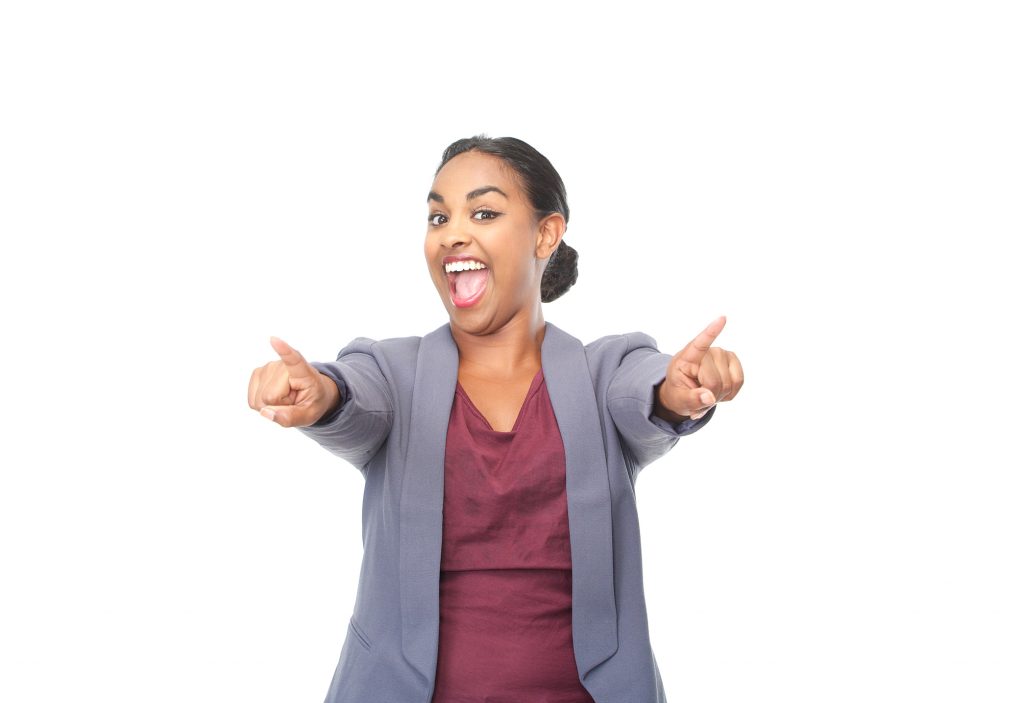 Businesswoman with an excited expression on her face, pointing her arms and fingers outwards