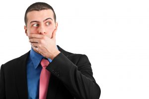 Businessman covering with his hand over his mouth