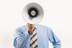 Businessman speaking into a megaphone