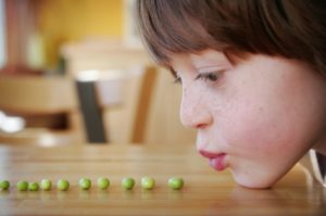 person blowing peas 