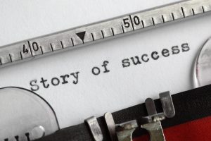 "Story of success" written on an old typewriter