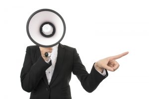 Business person speaking into a megaphone and pointing
