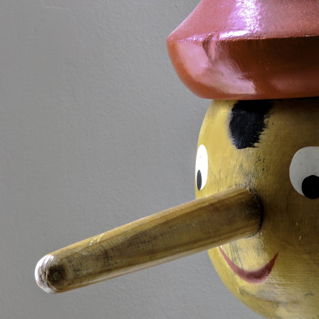 Wooden Pinocchio doll with an extended nose