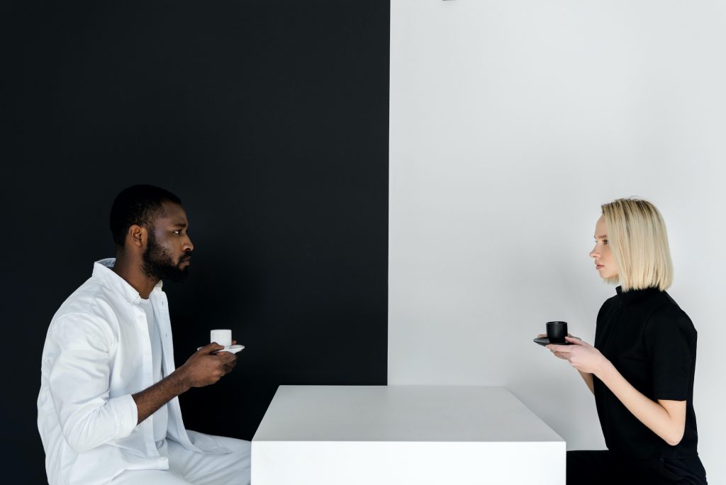 Man of color caucasian woman having a difficult conversation.