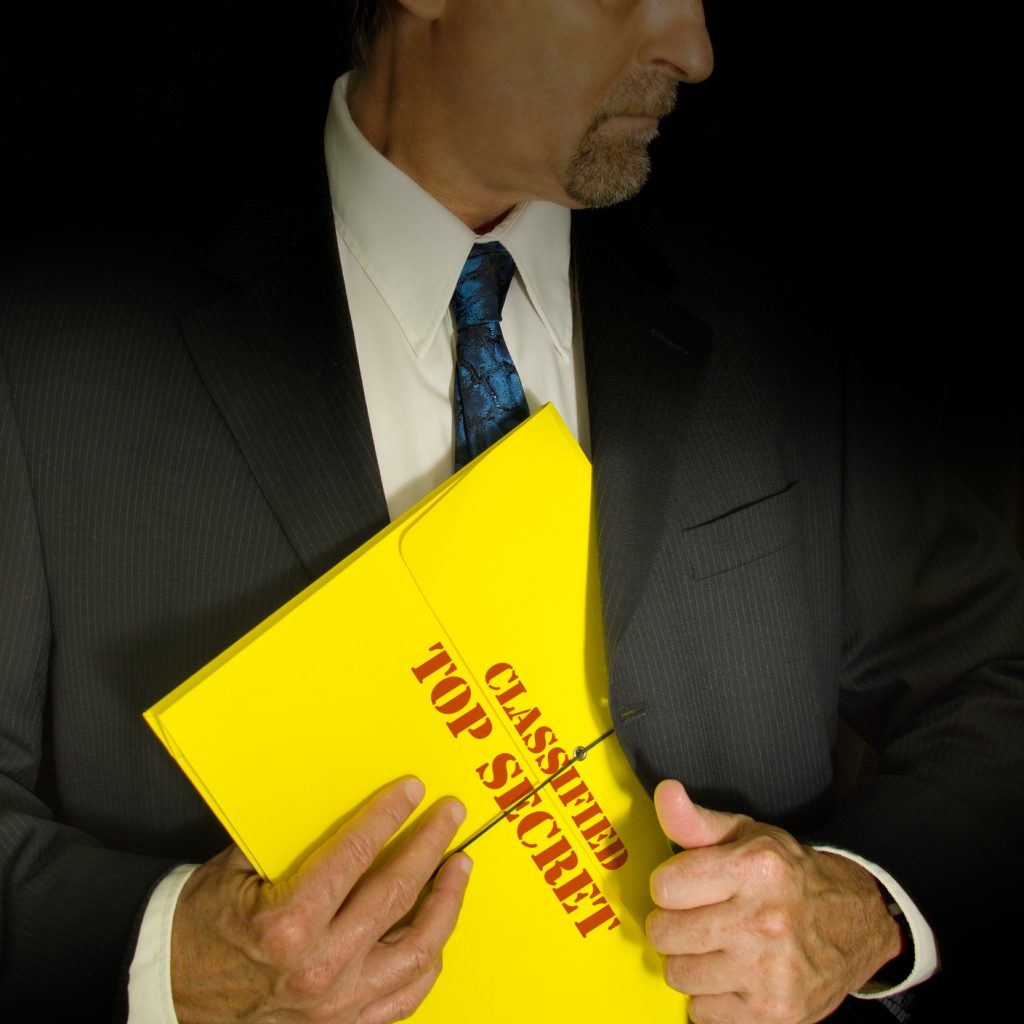 Businessman holding a top secret envelope with classified information