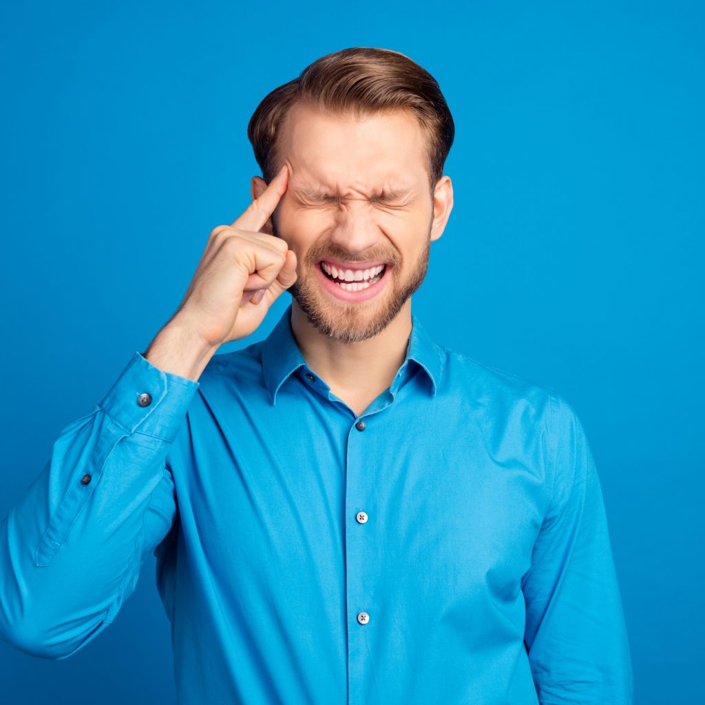 Man with his fingers to his temples, with a thinking expression