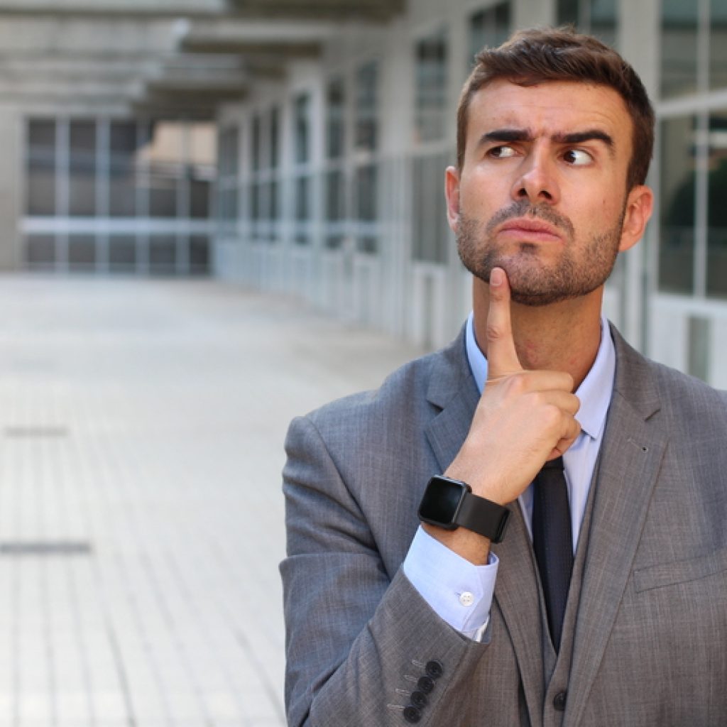 Businessman with a pondering/confused expression