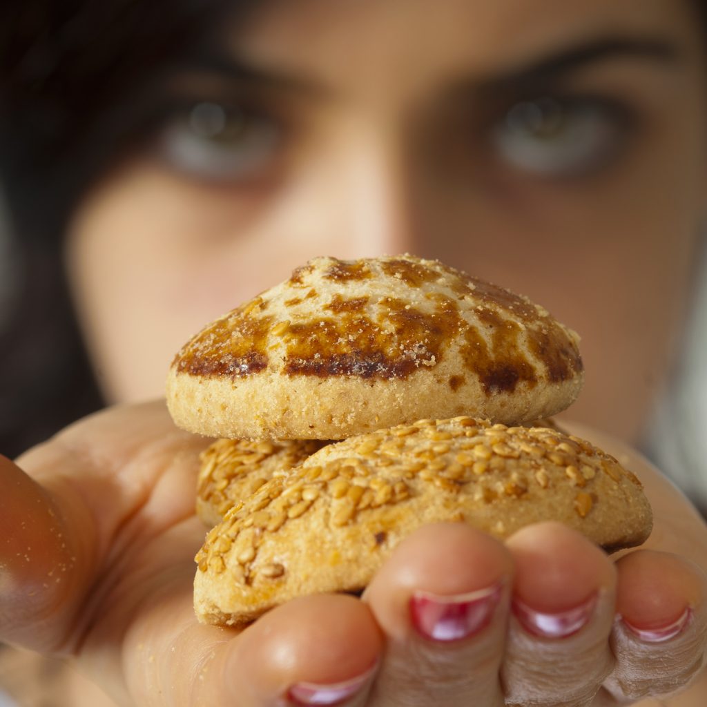 Women holding freshly baked cookies