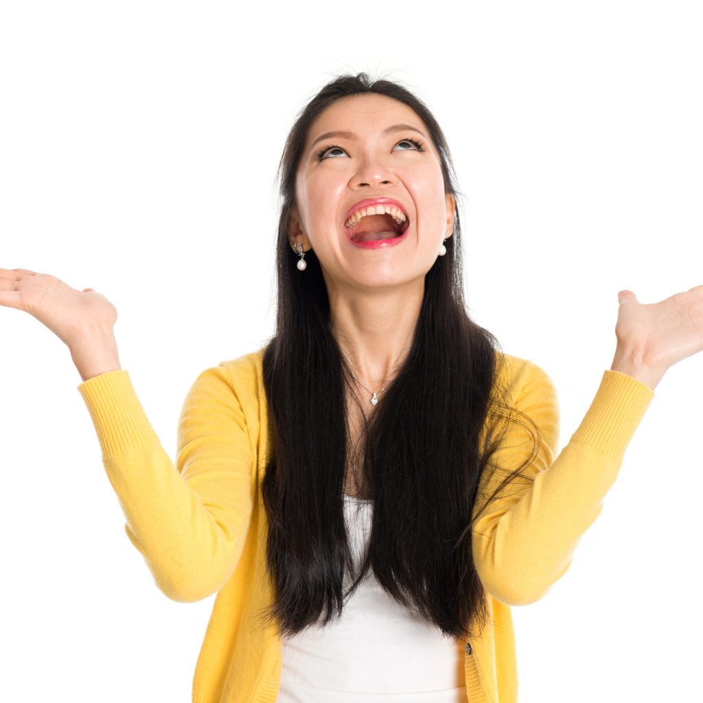 Women in a yellow sweater with a huge smile on her face