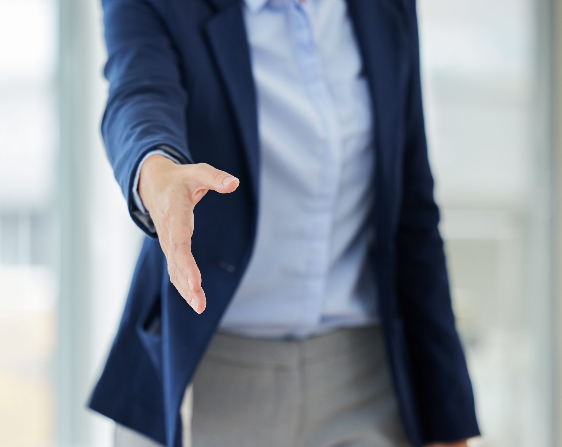 Hand reaching out to establish connection amongst the work place and create stable relationships through effective communication in conversations.