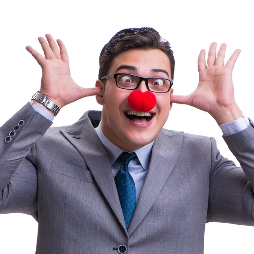 Businessman with a clown nose and glasses, making a silly face